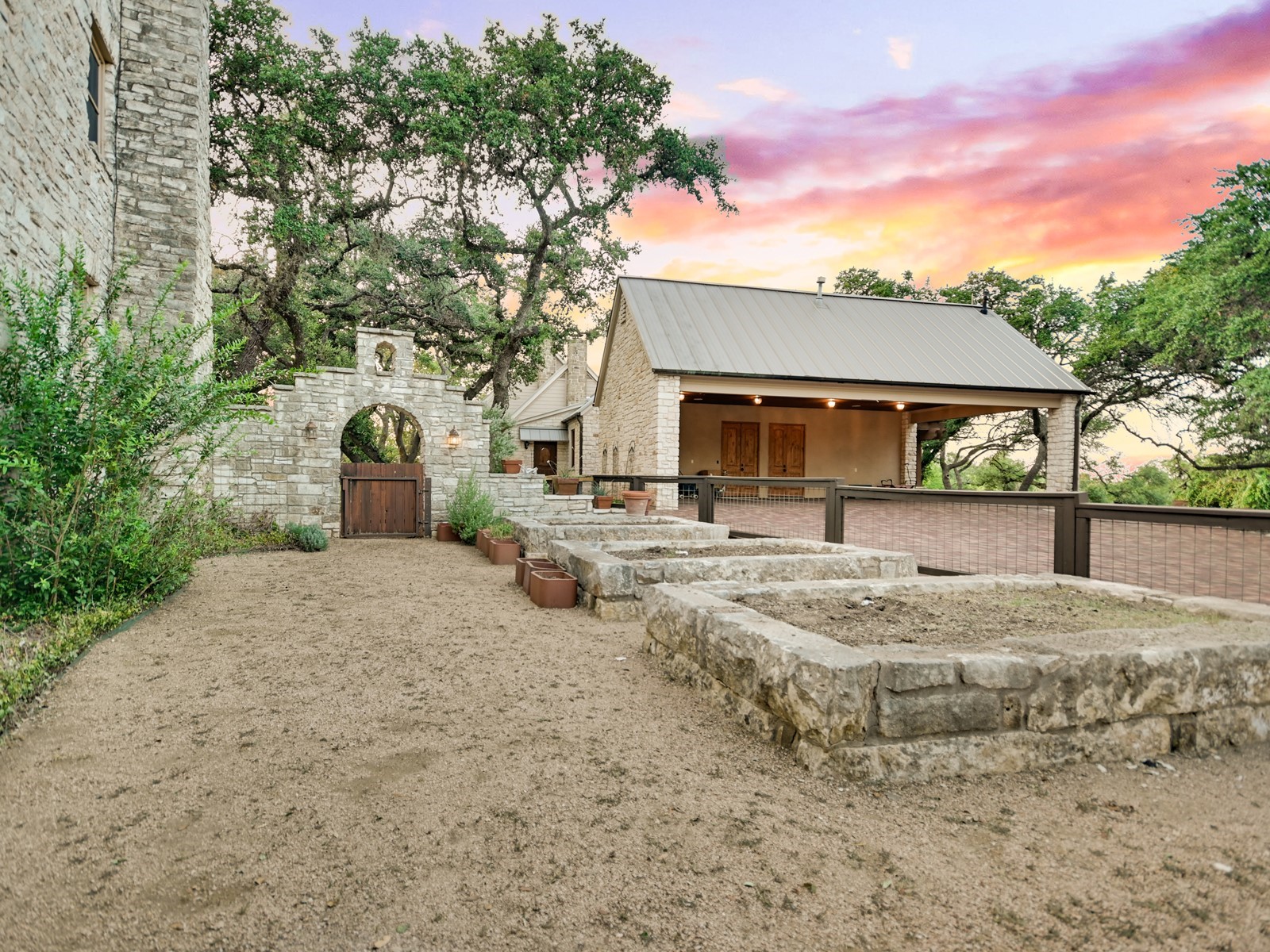 Sunrise over large estate and stone courtyard in Driftwood, Texas